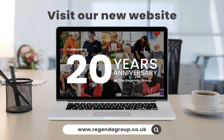 laptop on a desk with celebrating 20 years as the regenda group