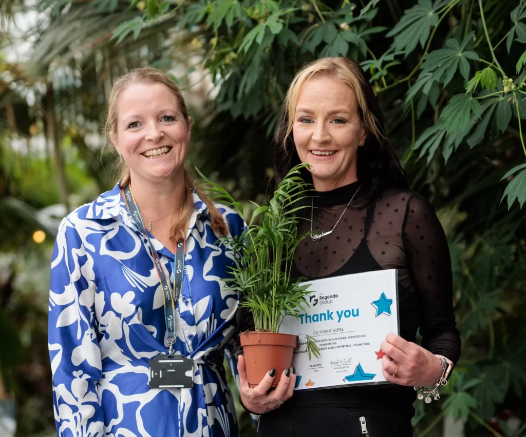 Regenda Customer Voice Awards 2026 - resident with certificate and plant awarded by Regenda staff member
